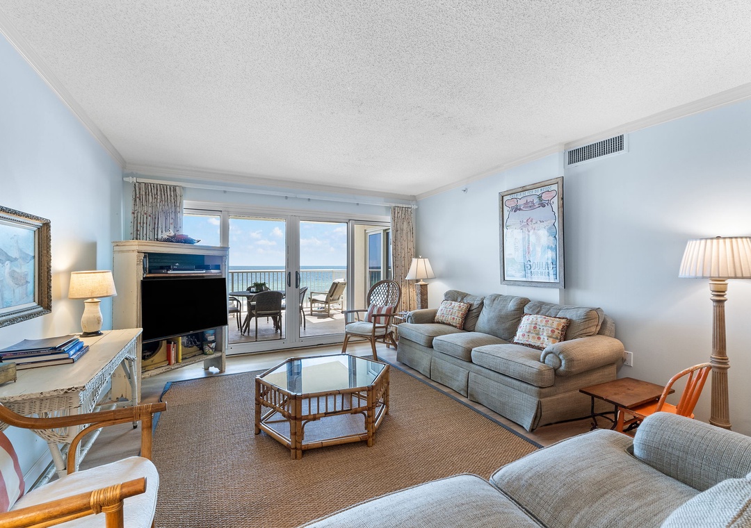 Sandy Key 338- Relax in your spacious living room, where soft sofas and warm lamps create the perfect spot to unwind. Step through the glass doors to your private balcony and take in the stunning ocean view.