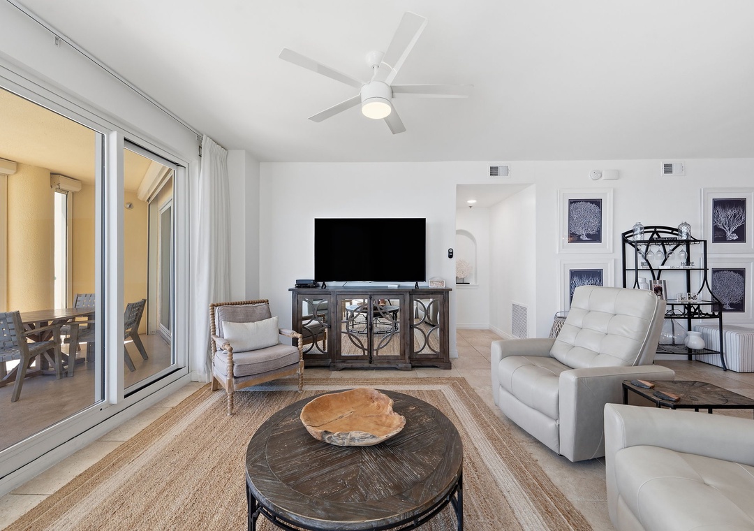 Beach Colony T14B- Settle into a bright, coastal living space with plush seating and natural textures. Your private balcony invites ocean breezes, while the cool tile floors and modern accents create the perfect retreat after sun-soaked days.