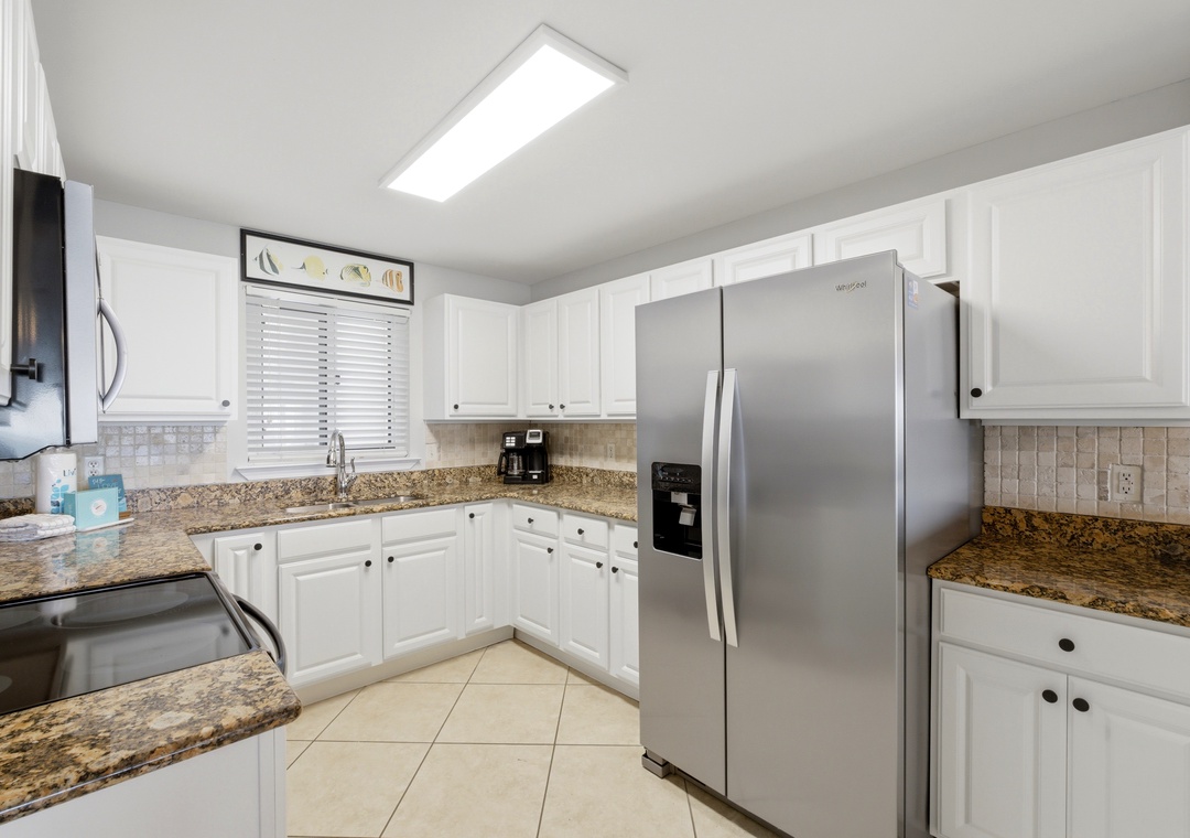 Sandy Key 318- You'll love preparing meals in this bright, fully equipped kitchen with granite countertops, stainless appliances, and plenty of storage space for all your cooking needs.