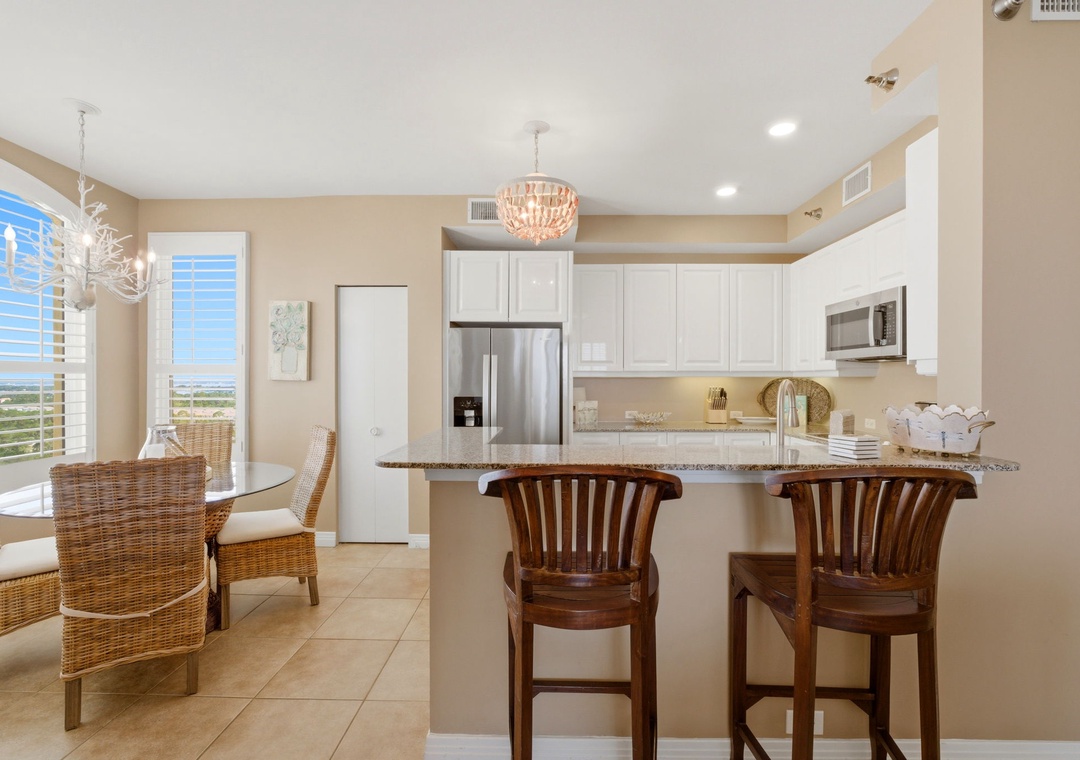 Beach Colony T PH1D- Gather around your granite breakfast bar or enjoy meals at the dining table—both with stunning views that make every moment feel special.