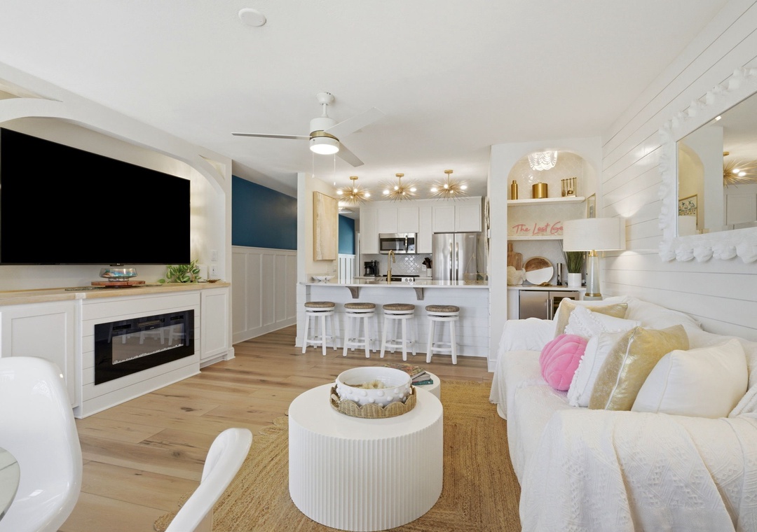 North Lost Key Landing B2- Relax in this bright, open-plan living space where coastal charm meets modern comfort. Sink into plush seating while the fireplace warms your evenings and the full kitchen invites you to create delicious meals together.