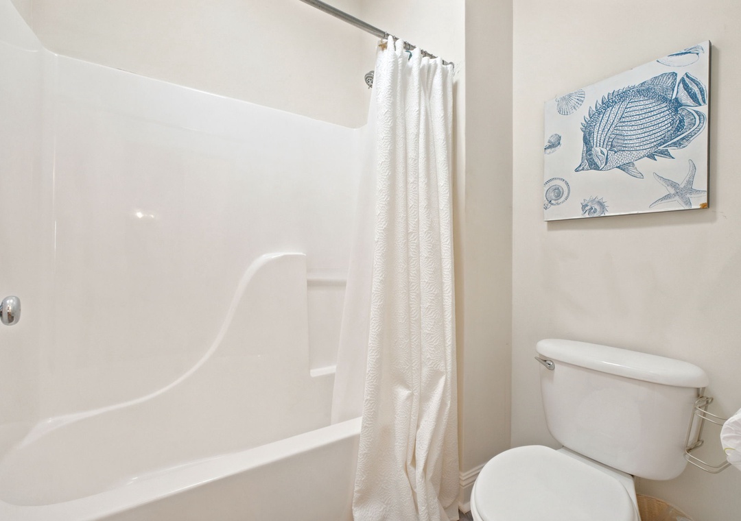 Relax in your private bathroom with a sparkling clean tub and shower. Coastal artwork and thoughtful touches create a refreshing retreat after a day of exploring.