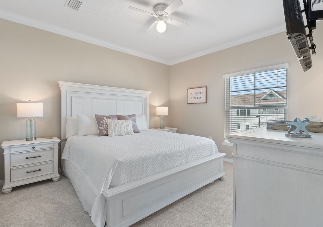 Saltwater & Sunsets- Settle into this airy bedroom with coastal charm, featuring a plush bed, soft lighting, and calming neutral tones that invite restful nights and peaceful mornings.