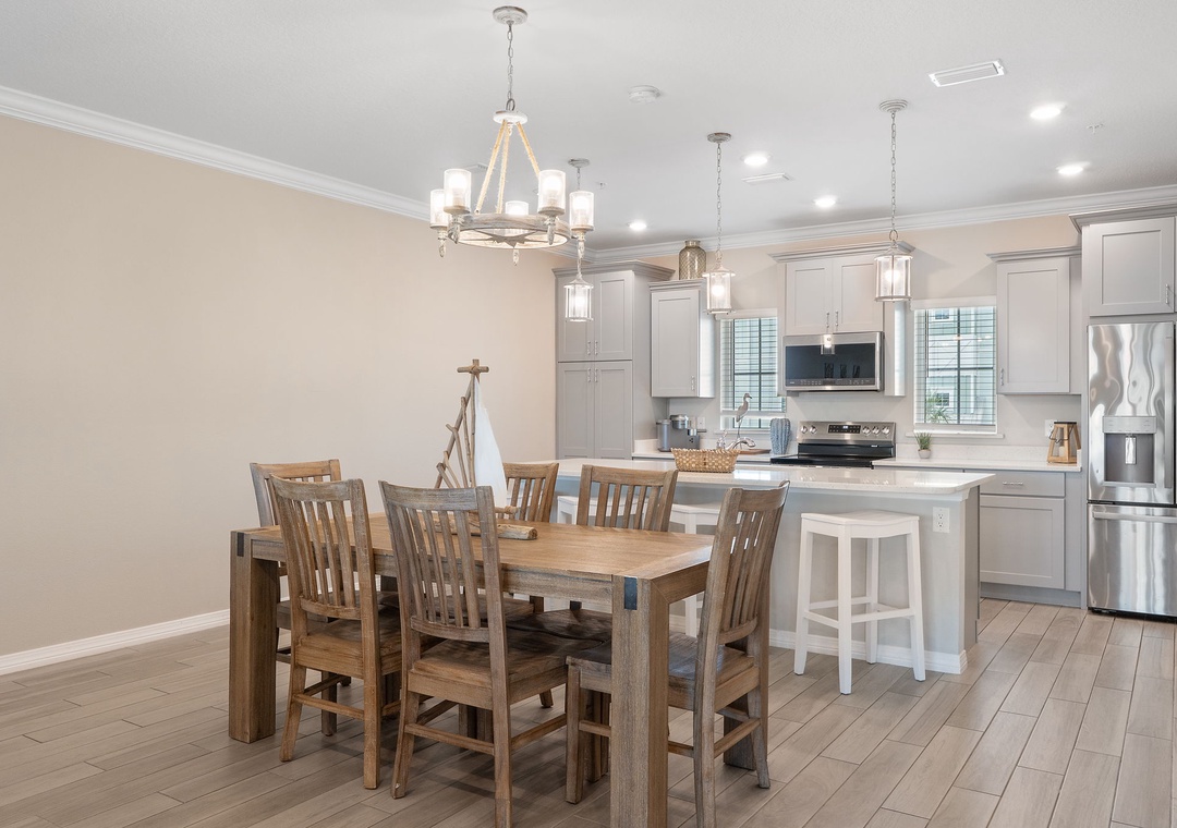 Saltwater & Sunsets- Gather around this spacious dining table where your group can share meals and laughter. The open kitchen invites you to cook together, with modern appliances and a center island for easy meal prep.