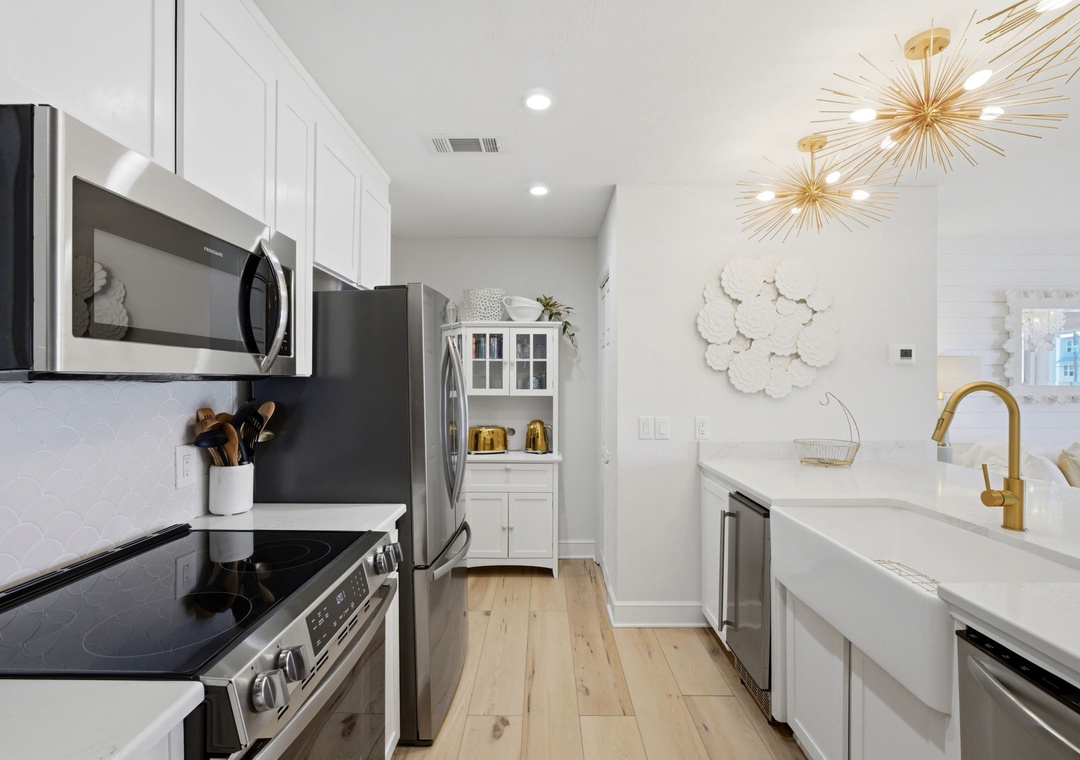 North Lost Key Landing B2- Your fully equipped kitchen features modern appliances, gleaming countertops, and elegant gold fixtures—ready for your morning coffee or a home-cooked meal.