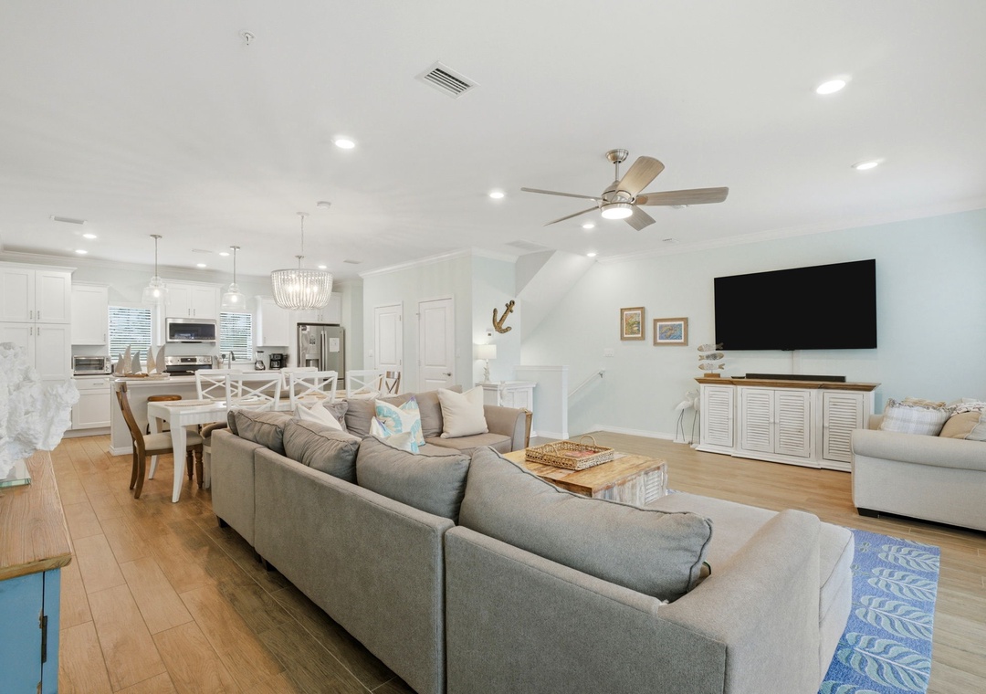 Sink into plush seating in your spacious open-concept living space, where coastal charm meets modern comfort, perfect for gathering with loved ones.