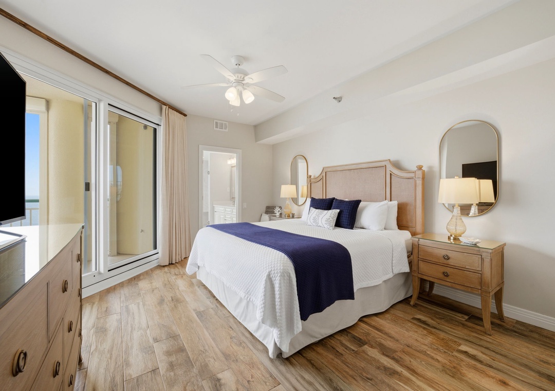 Beach Colony Tower PH1B -Sink into crisp linens and coastal charm in your serene bedroom retreat. Step out to your private balcony and let the ocean breeze refresh you after a day of adventure.