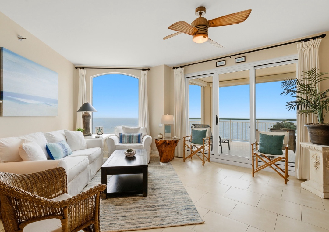 Beach Colony Tower PH1B -Relax in this bright, coastal living room where ocean breezes flow through French doors onto your private balcony. Plush seating and tranquil sea views create the perfect retreat for your beach getaway.