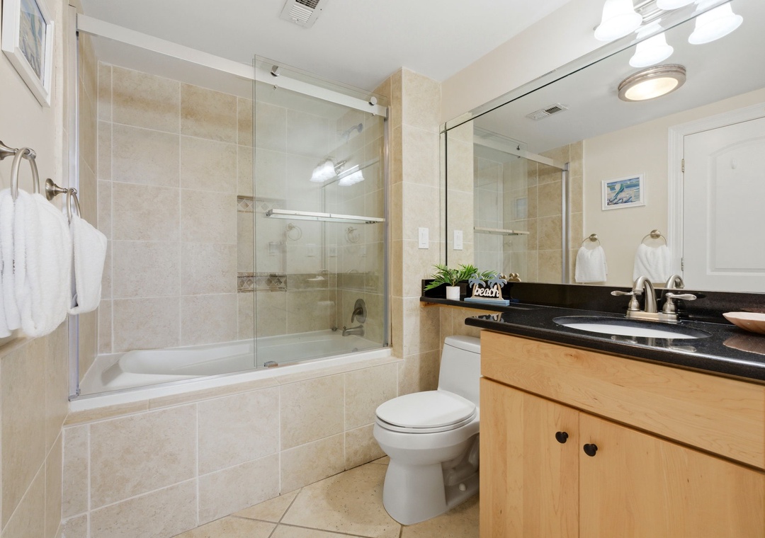 Shipwatch D803- Step into your bright, spa-like bathroom with sleek tile, a deep soaking tub, and plush towels awaiting your arrival.