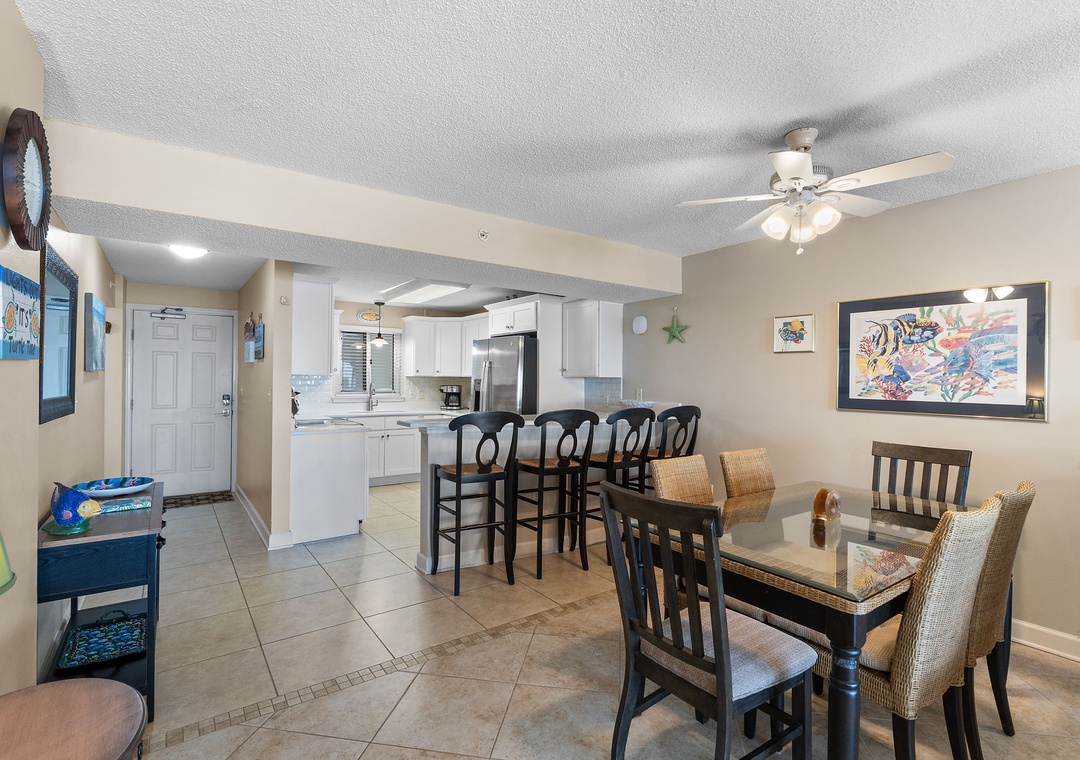 Sandy Key 628- Step into your bright, open-concept living space where coastal charm meets comfort. Gather around the dining table for meals, or pull up a stool at the kitchen bar to enjoy a morning cup of coffee.
