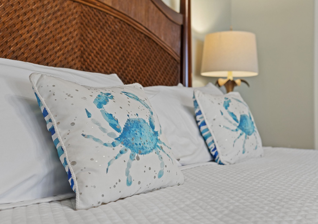 Beach Colony T15B- Coastal charm greets you with soft linens and inviting blue crab accents—your perfect retreat after a day of exploring.