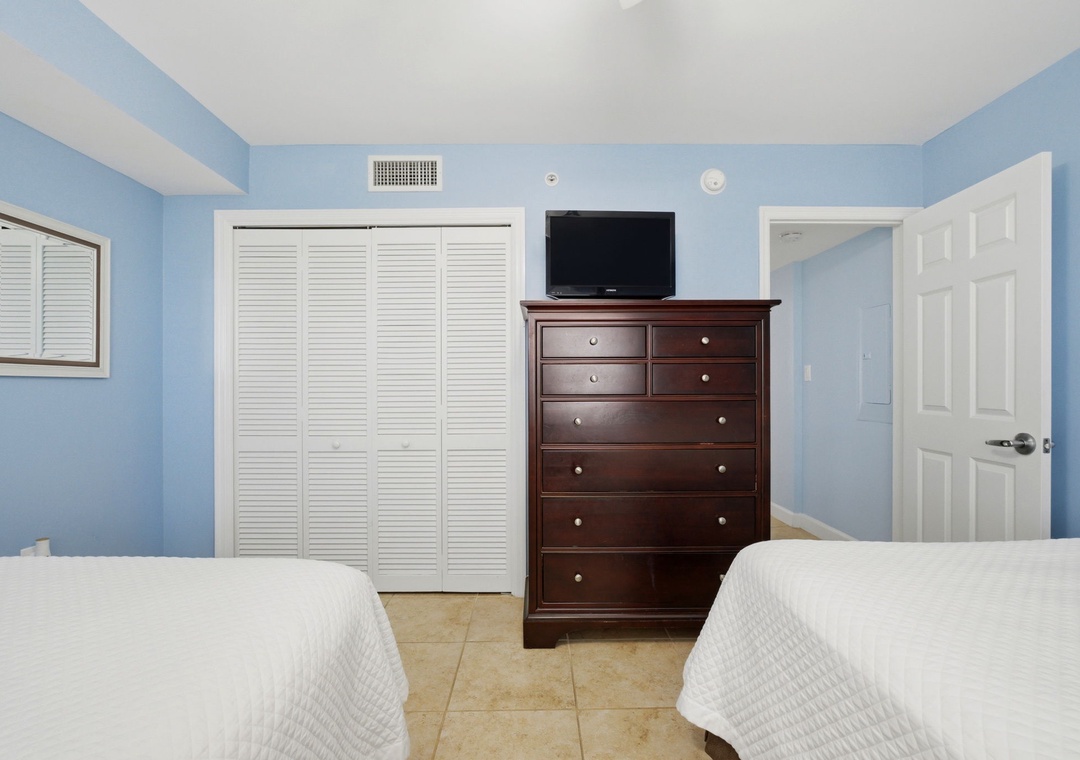 Sandy Key 637- Relax in this peaceful bedroom with two plush beds, ample storage, and climate-controlled comfort—your restful retreat awaits after a day of exploring.