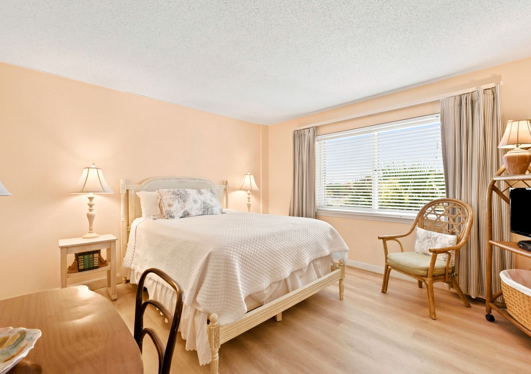 Sandy Key 338- Sink into soft linens on your comfortable bed and wake up refreshed in this serene, light-filled bedroom with charming coastal-inspired furnishings and plenty of natural light.