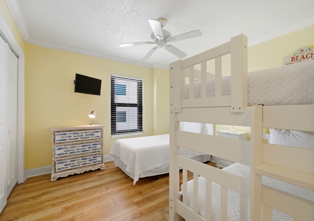 Ocean Breeze E601- Your bright beach-themed retreat features fresh linens, a ceiling fan to keep you cool, and a bunk bed that's perfect for the kids to enjoy their own adventure while you relax.