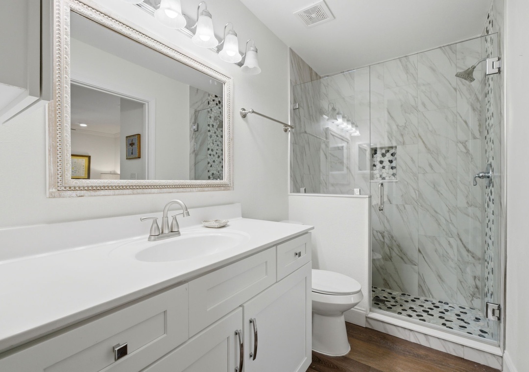 Grand Caribbean 305W- Step into your serene spa-like bathroom with its elegant marble shower, gleaming fixtures, and bright, airy design—your perfect retreat after a day of exploring.