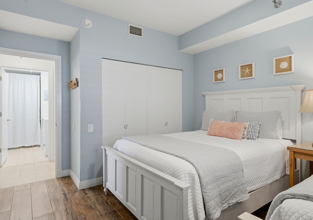 Beach Colony Tower PH1B -Settle into your peaceful coastal retreat with soothing blue-gray walls, crisp white linens, and beachy accents that make unwinding effortless. Wake refreshed under high ceilings with plenty of room for everyone.