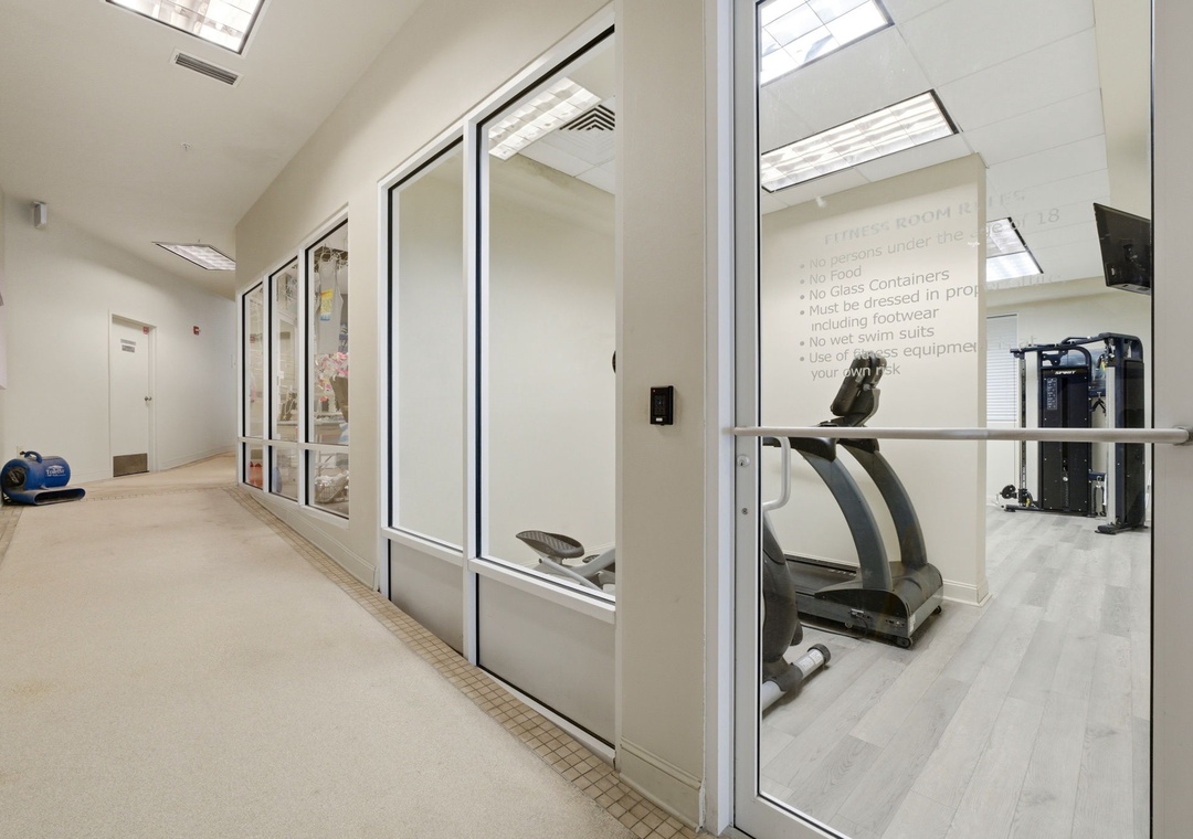 Modern fitness centre with cardio equipment and free weights, ready for your workout routine in a bright, well-equipped space.