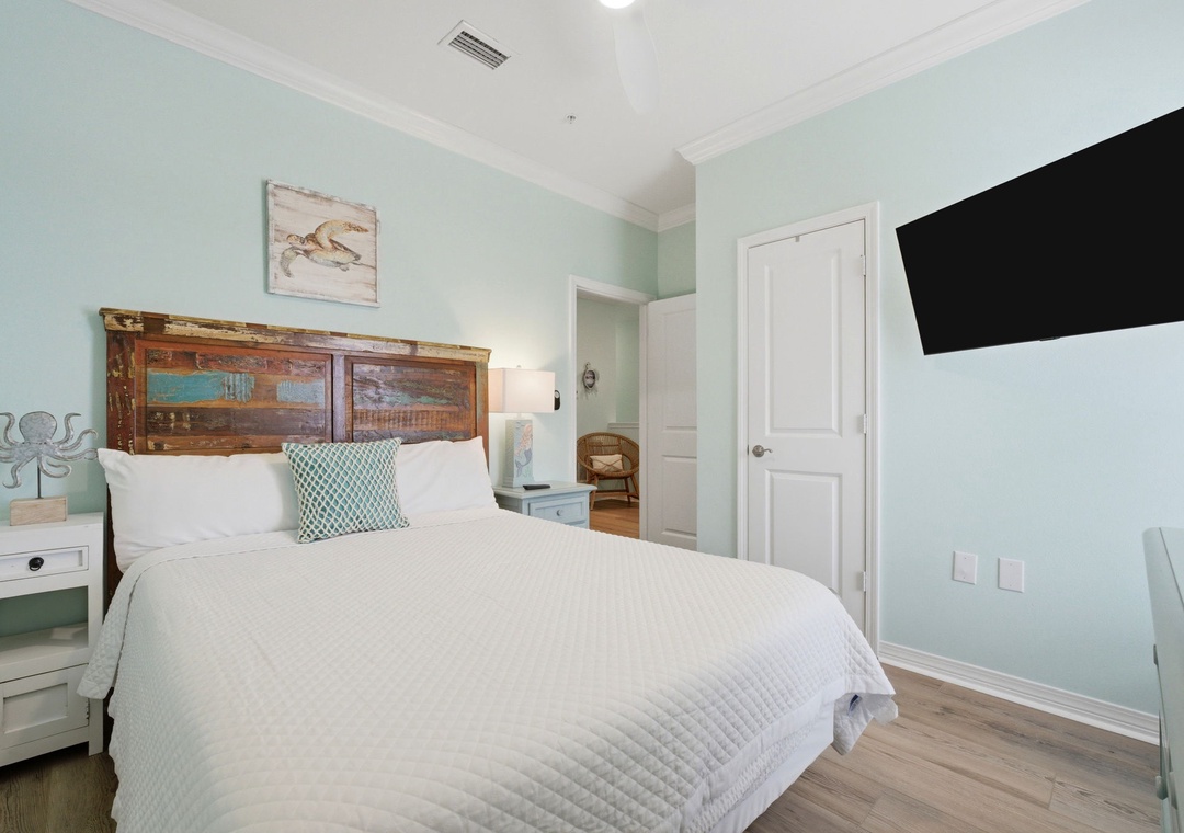 Drift off in this coastal-inspired bedroom where soft seafoam walls and crisp linens create your perfect retreat. Thoughtful details like warm wood accents and beach-themed art set a soothing tone for restful nights.