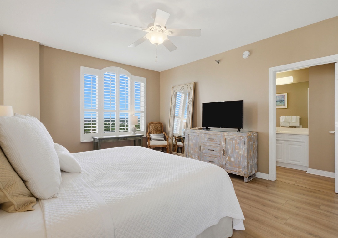 Beach Colony T PH1D-Sink into crisp linens and wake to coastal views through your shuttered windows. A ceiling fan keeps you comfortable while flat-screen TV and ensuite bath add convenience to your restful retreat.