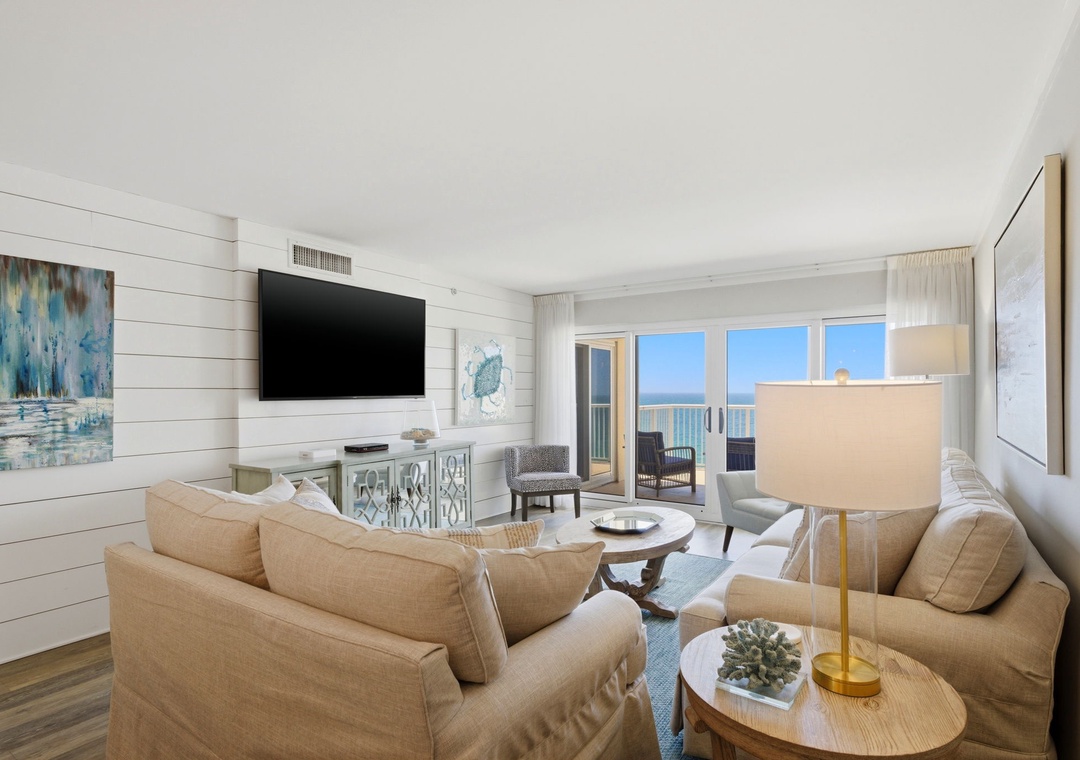 Sandy Key 827- Step into your bright coastal retreat where soft beige sofas frame stunning ocean views. Relax in this thoughtfully designed space with beach-inspired artwork, modern amenities, and your own private balcony overlooking turquoise waters.