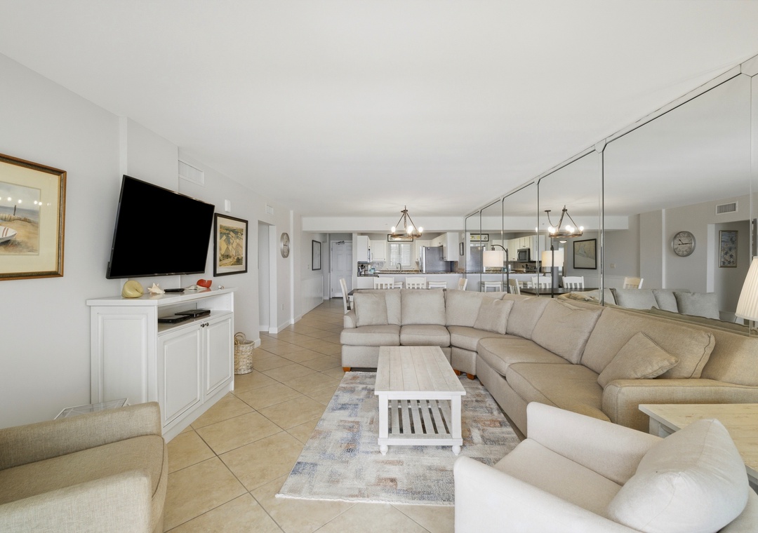 Sandy Key 318- Step into your spacious, sunlit retreat where plush seating invites you to unwind. The open-plan living flows seamlessly into a fully-equipped kitchen, perfect for preparing meals or entertaining with ease.