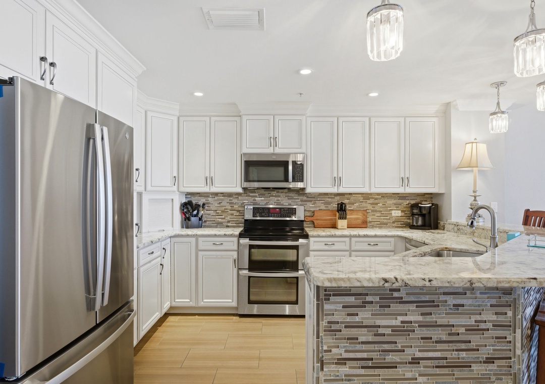 Your gourmet kitchen awaits with granite countertops, stainless steel appliances, and a spacious island—perfect for whipping up vacation meals and morning coffee together.
