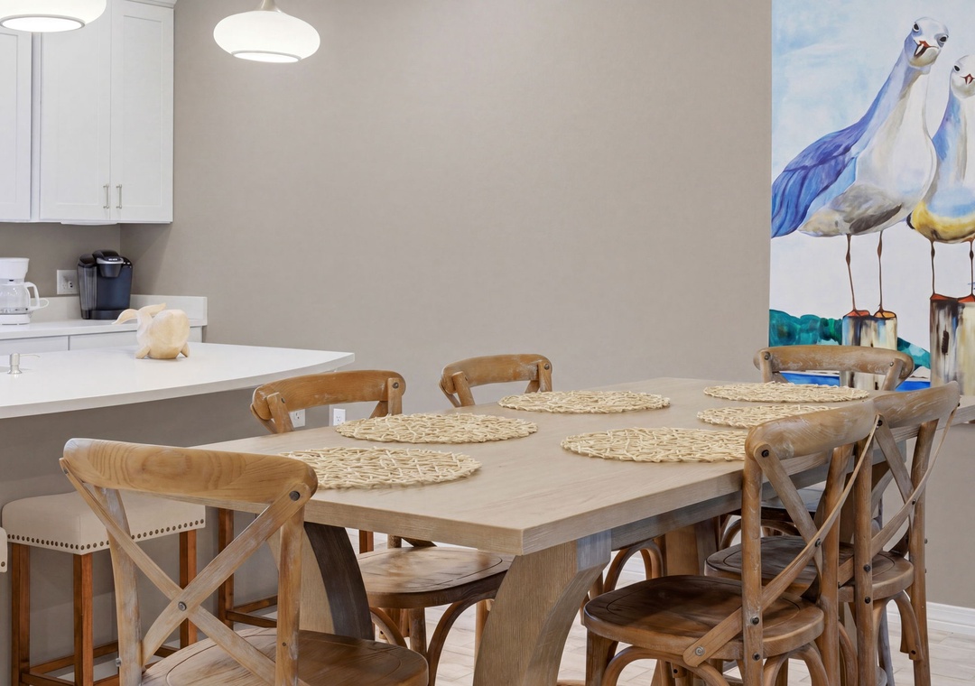Turtles Nest- Gather around this spacious dining table where six chairs await your family's laughter and shared meals, with a bright kitchen just steps away for easy hosting.