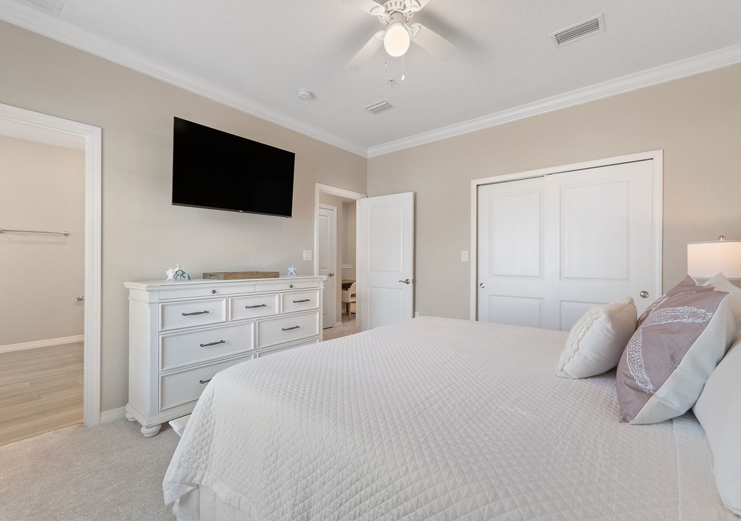 Saltwater & Sunsets- Settle into crisp linens and soft pillows in your serene bedroom retreat. Relax with entertainment, store your belongings in the spacious dresser, and enjoy the ceiling fan's gentle breeze.