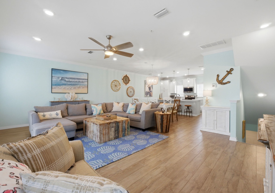 Step into your coastal retreat—open, airy, and beautifully designed. Relax on plush seating in the living room, then gather with family in the modern kitchen for memorable meals.