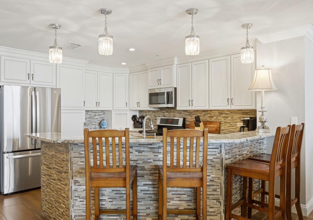 Picture yourself preparing meals in this bright kitchen with gleaming stainless appliances, ample counter space, and a stylish island where your group can gather for casual conversation.