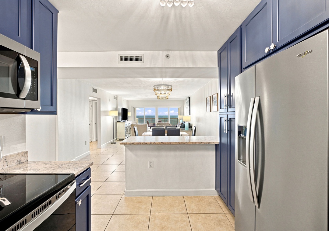 Sandy Key 411- Your bright, fully equipped kitchen flows seamlessly into the living area, where ocean views frame every moment of your stay.