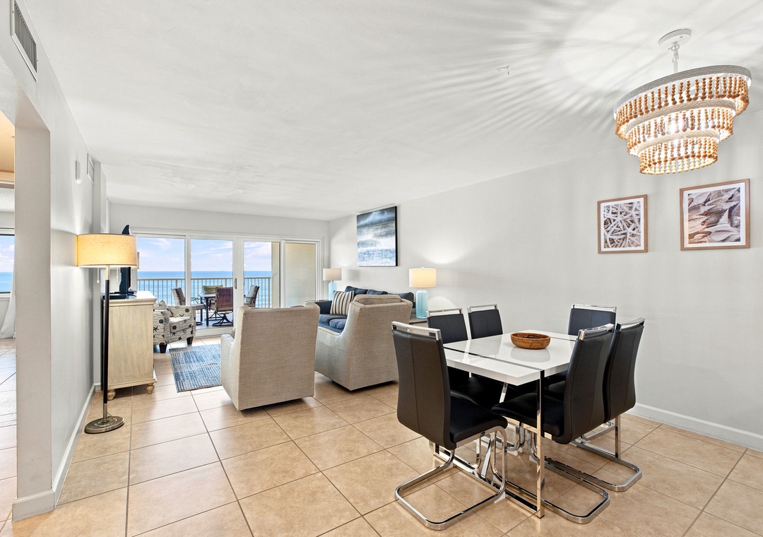Sandy Key 411- Bright, open living spaces flow seamlessly into your coastal dining area, where ocean views through the balcony doors create the perfect backdrop for meals together.