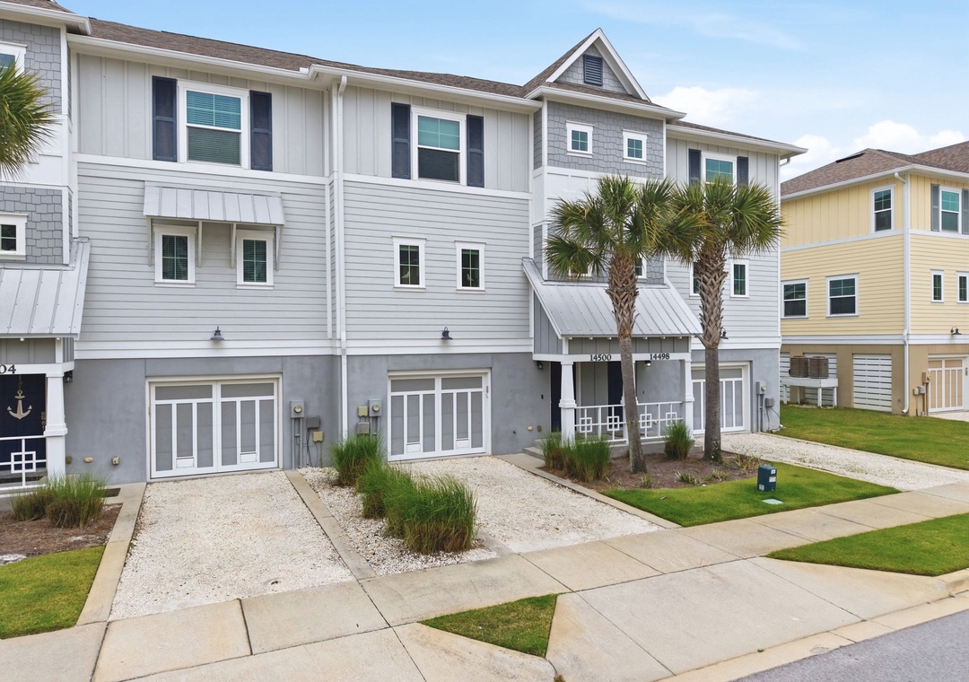 Turtles Nest- A modern coastal-style property in a well-maintained neighborhood, featuring contemporary architecture with coastal landscaping and convenient parking access.