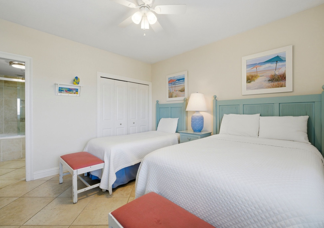 Shipwatch D803- Drift off in crisp white linens and turquoise coastal charm, with two cozy beds ready to cradle your beach-day dreams under the gentle glow of a ceiling fan.