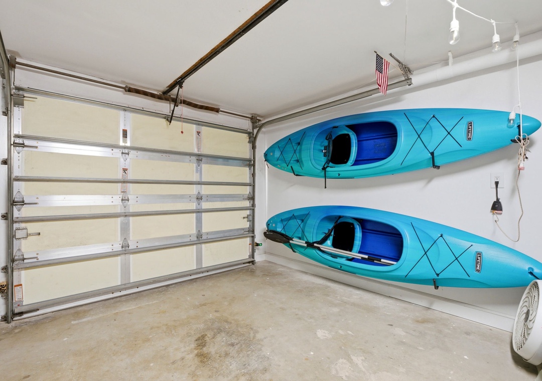 North Lost Key Landing B2- Two kayaks ready for your next waterfront adventure, safely stored in the private garage for easy access whenever you're ready to explore.