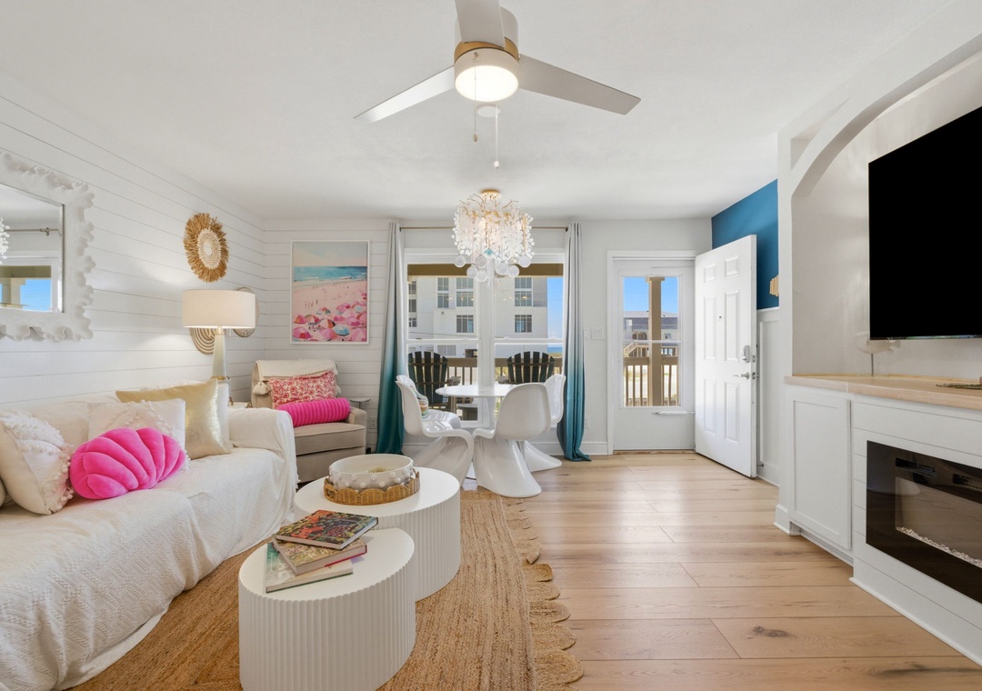 North Lost Key Landing B2- Relax in your bright coastal living room with plush seating, ocean-inspired accents, and French doors opening to a private balcony perfect for morning coffee or evening sunsets.