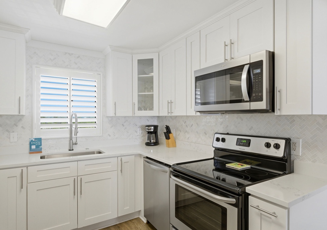 Sandy Key 827- Your spotless kitchen awaits, complete with modern appliances, sleek cabinetry, and natural light streaming through a skylight—perfect for preparing meals with ease.