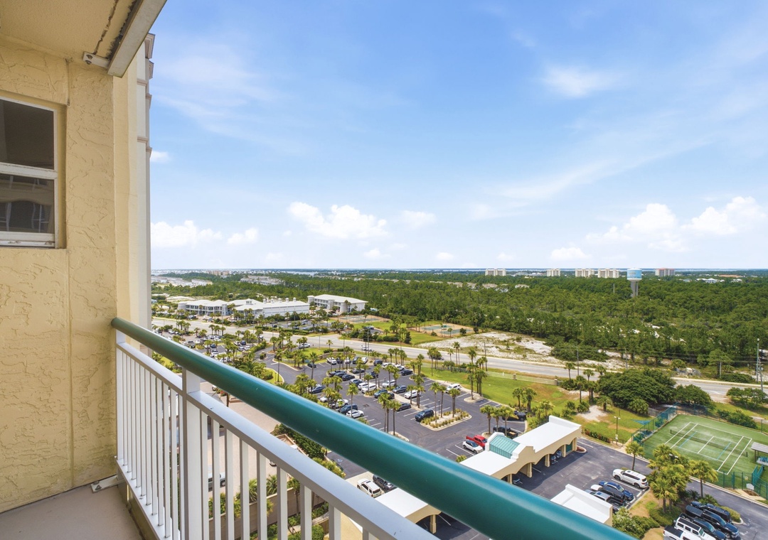 Beach Colony W13A- Sweeping views stretch across lush landscapes, tennis courts, and parking areas below, offering a peaceful vantage point from your private balcony.