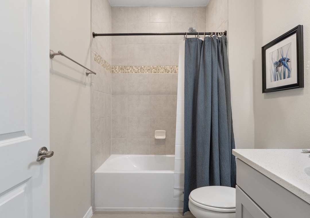 Saltwater & Sunsets-Your private bathroom offers everything you need to refresh, with a sleek shower-tub combo and neutral coastal tones that create a calming retreat.