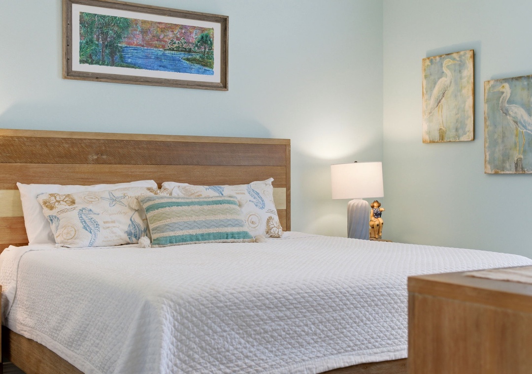 Sink into this serene coastal retreat featuring a plush bed, calming sea-inspired decor, and soft lighting to help you unwind after your adventures.