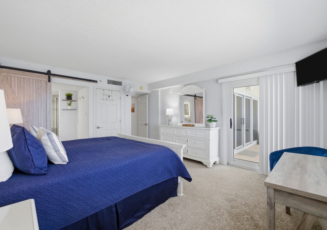 Drift off in your serene coastal retreat with crisp white finishes and charming barn door accents. Unwind in spacious comfort with plush bedding, climate control, and your own entertainment.