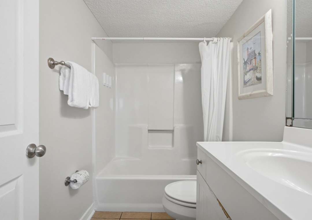 Ocean Breeze E702- Your private bathroom offers a clean tub-shower combo, fluffy white towels, and plenty of space to refresh after a day of exploring.