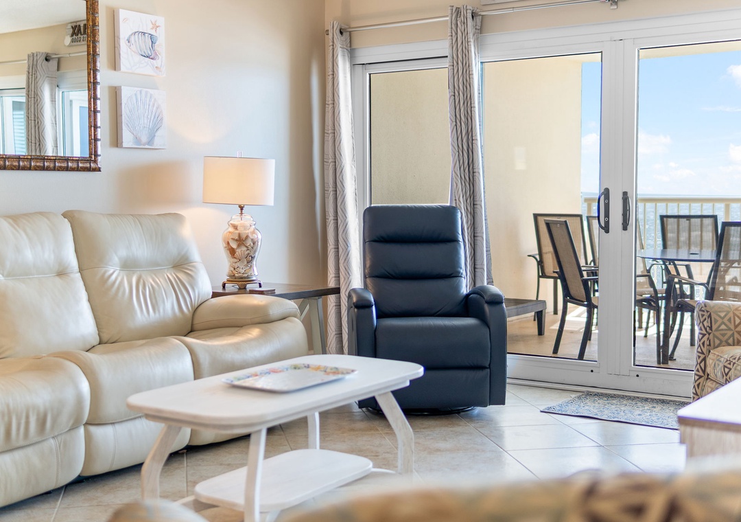 Sandy Key 628- Sink into the plush recliner or stretch out on the cozy sofa—your bright, beachy living room opens onto a private balcony where calm waters and endless sky await.