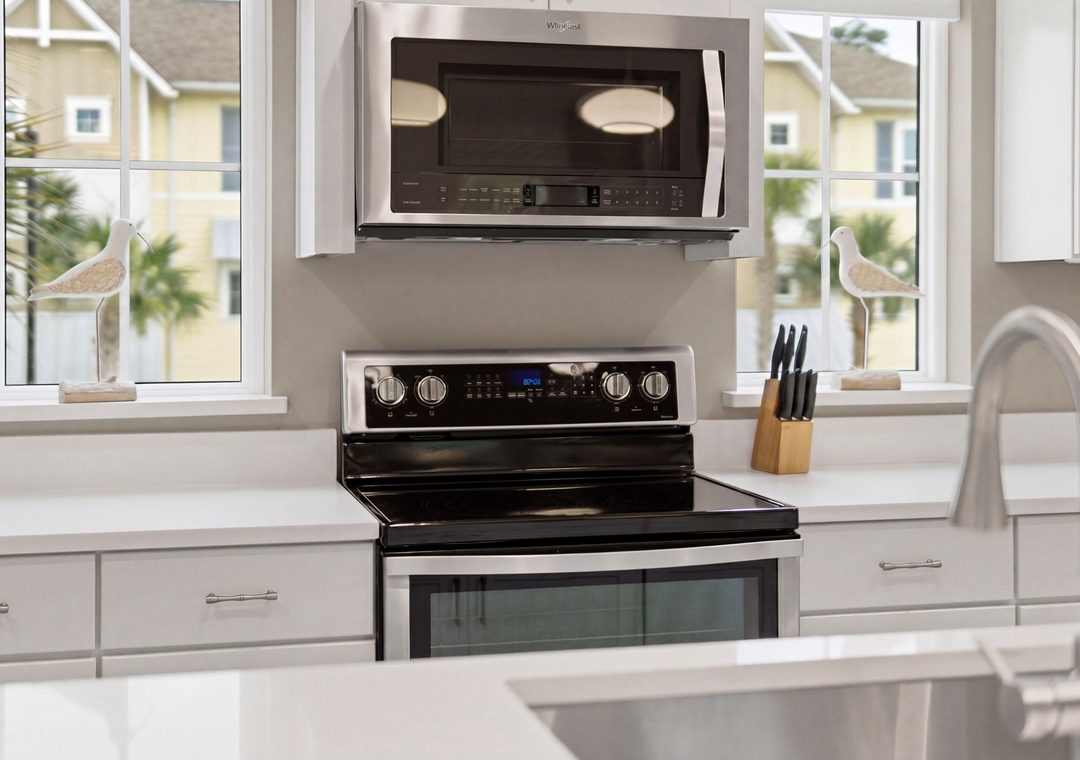 Turtles Nest- Cook your favorite meals in this bright, modern kitchen with stainless steel appliances, plenty of counter space, and natural light streaming through large windows overlooking palms.