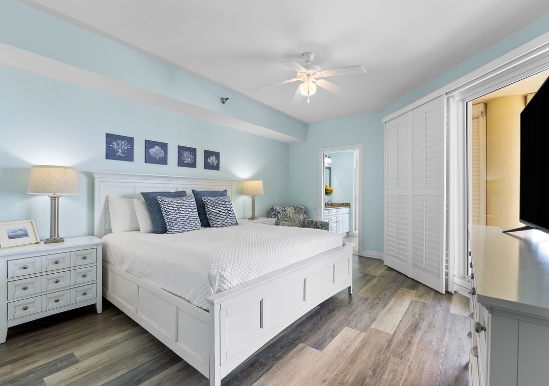 Beach Colony Tower 10C- Drift off in your serene coastal retreat, where soft blue tones and crisp white linens create a peaceful atmosphere. Your private ceiling fan keeps you comfortable year-round.