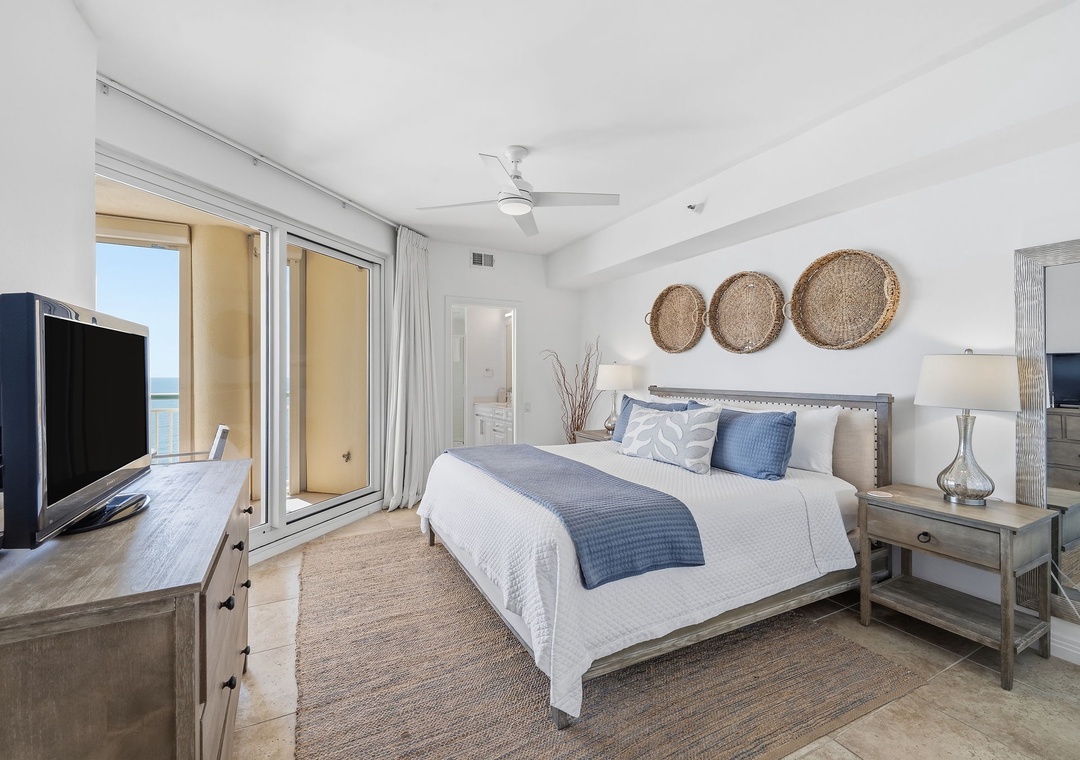 Beach Colony T14B- Drift off in this coastal-chic bedroom where soothing blues meet soft whites. Natural textures add warmth while your private balcony opens to ocean breezes—a peaceful retreat designed just for you.