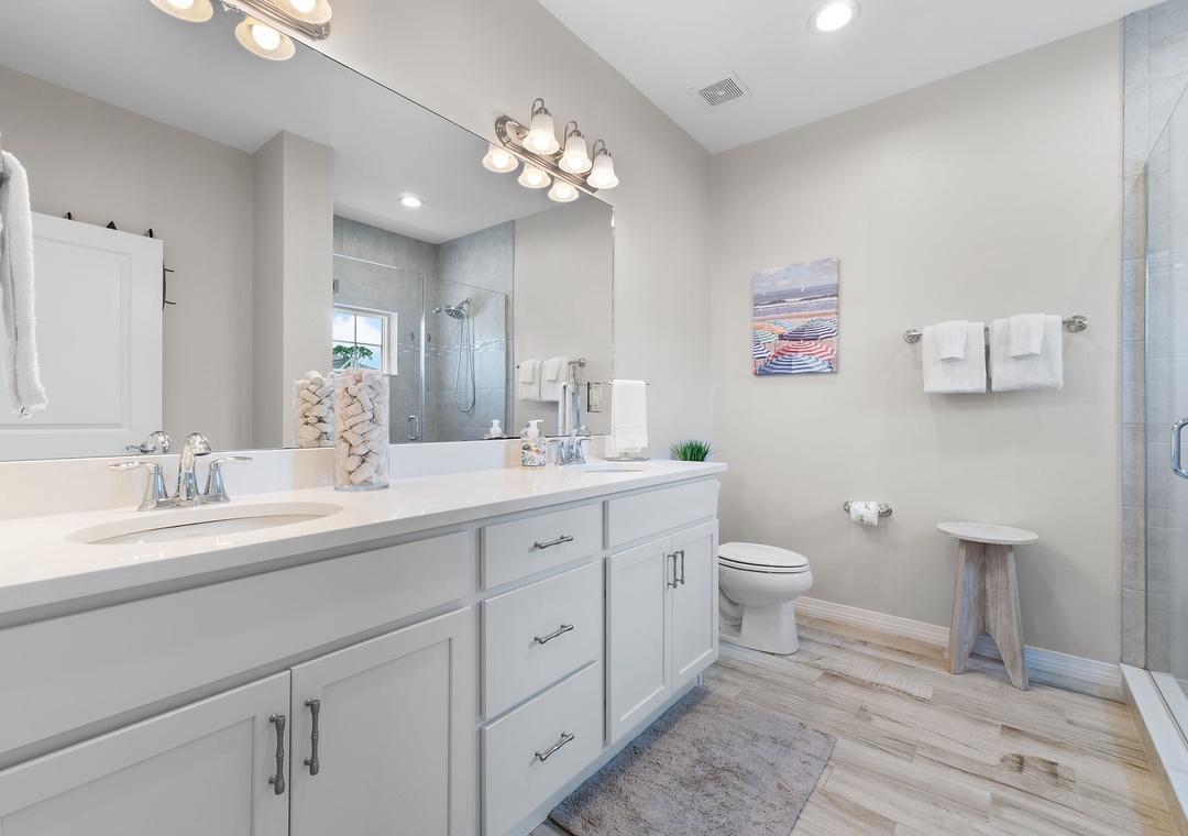 Turtles Nest- Step into your private sanctuary with gleaming dual vanities, a rainfall shower, and coastal-inspired touches throughout. Fresh linens and bright finishes make every morning feel like a fresh start.