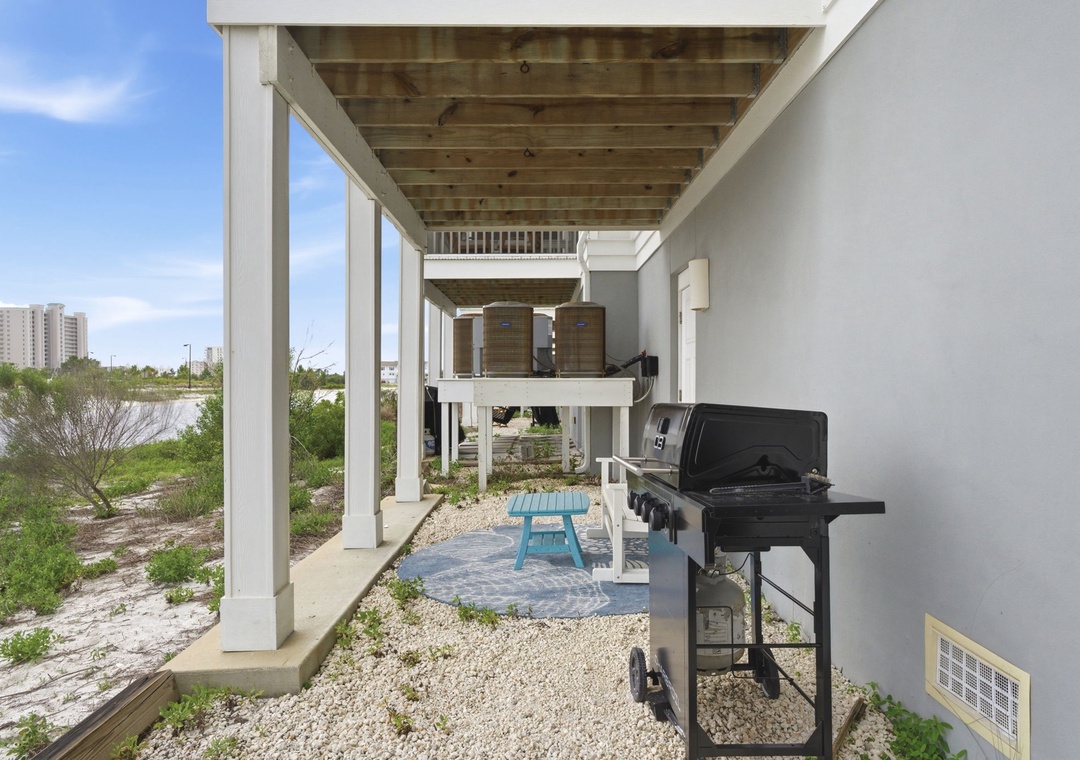 A covered outdoor space featuring modern architecture and coastal design elements, with high-rise buildings visible in the surrounding area.