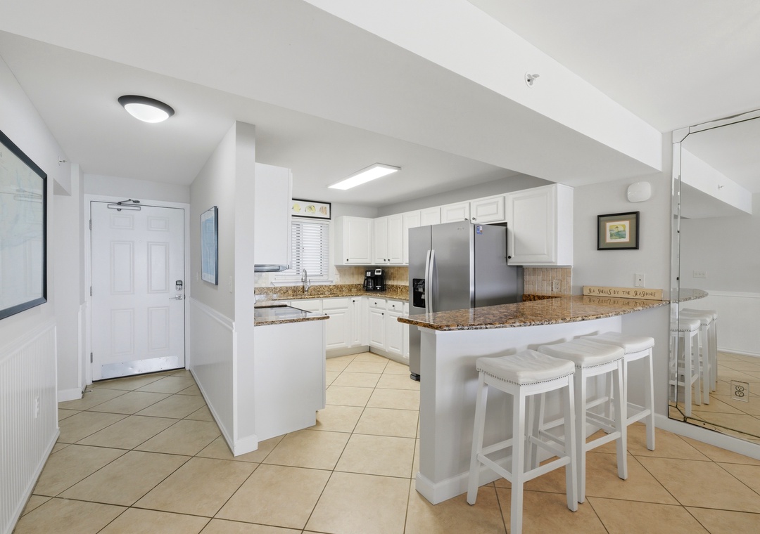 Sandy Key 318- You'll love preparing meals in this bright, spacious kitchen featuring granite countertops, modern stainless appliances, and a welcoming breakfast bar perfect for morning coffee or casual dining with family.