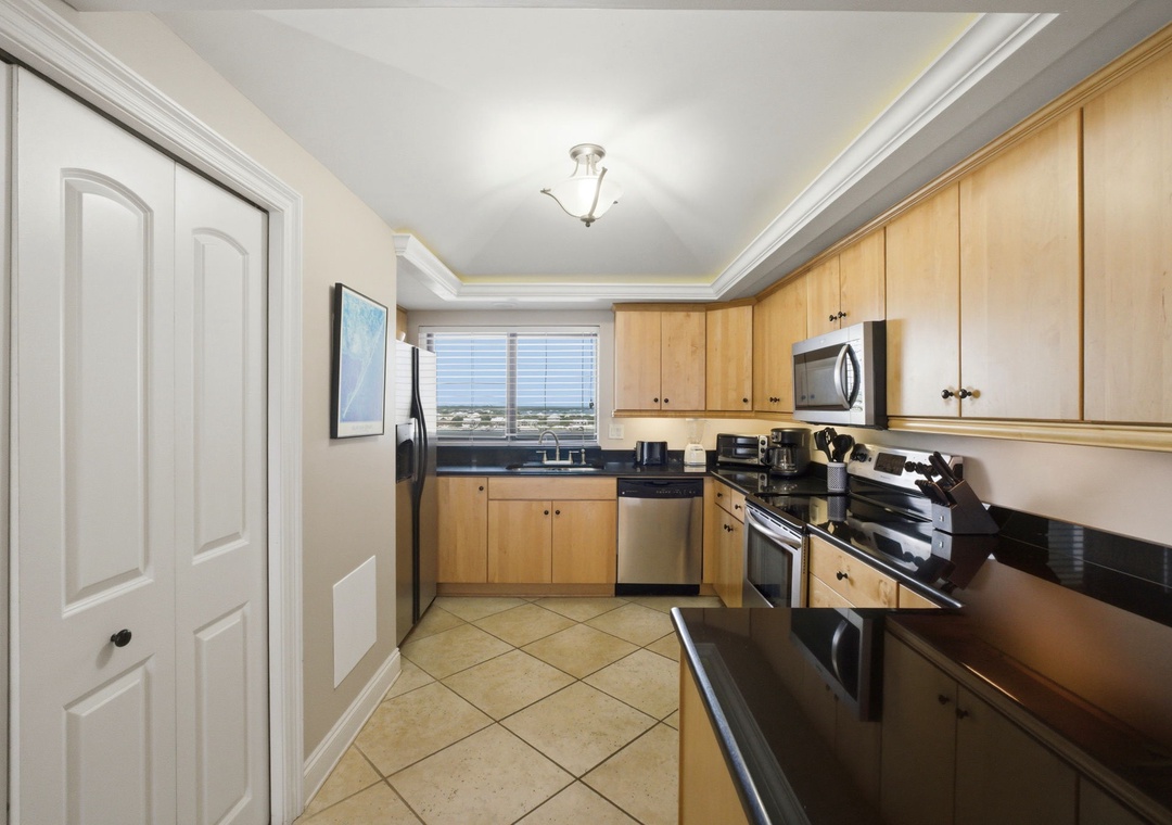 Shipwatch D803- Step into your fully-equipped kitchen with modern stainless steel appliances and warm wood cabinetry, where you can whip up meals while soaking in natural light and scenic views through the window.